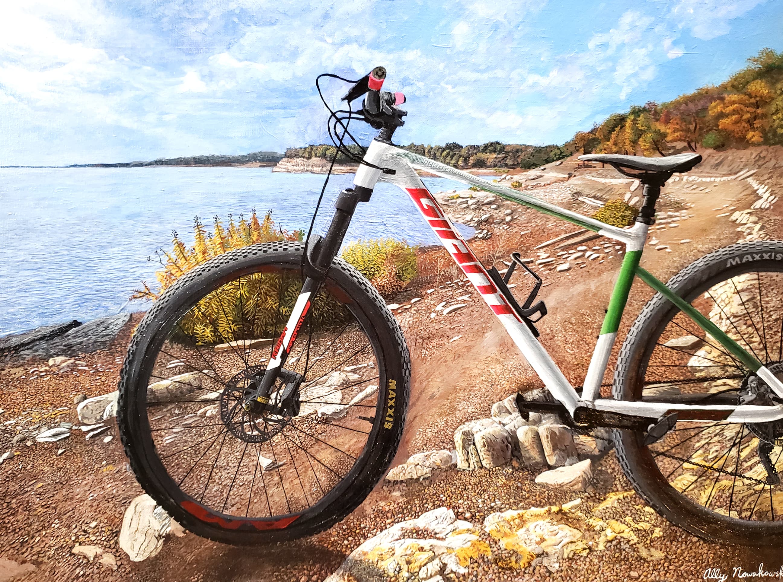 Painted commission of a green mountain bike on a lakeside with autumn trees, by Ally Nowakowski.