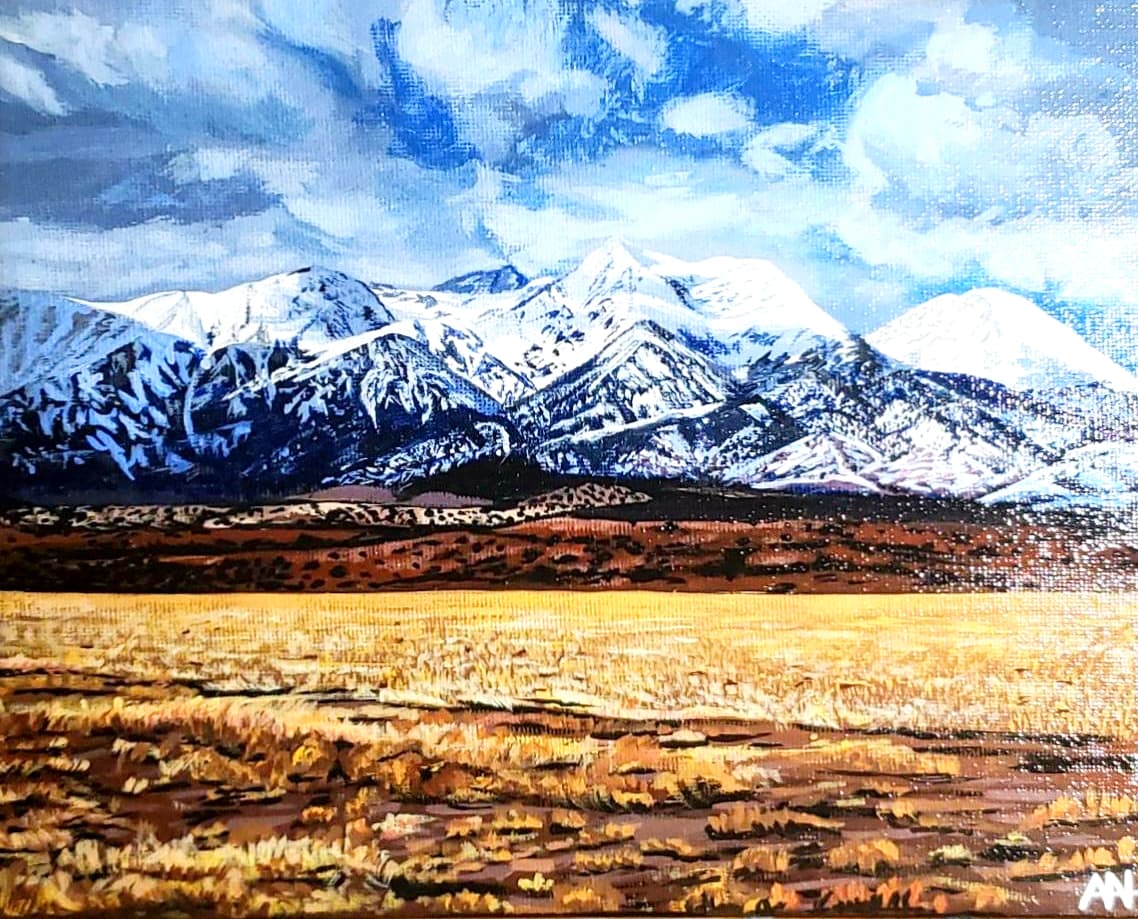Painted landscape of snow-capped mountains over a golden grass field, by Ally Nowakowski.